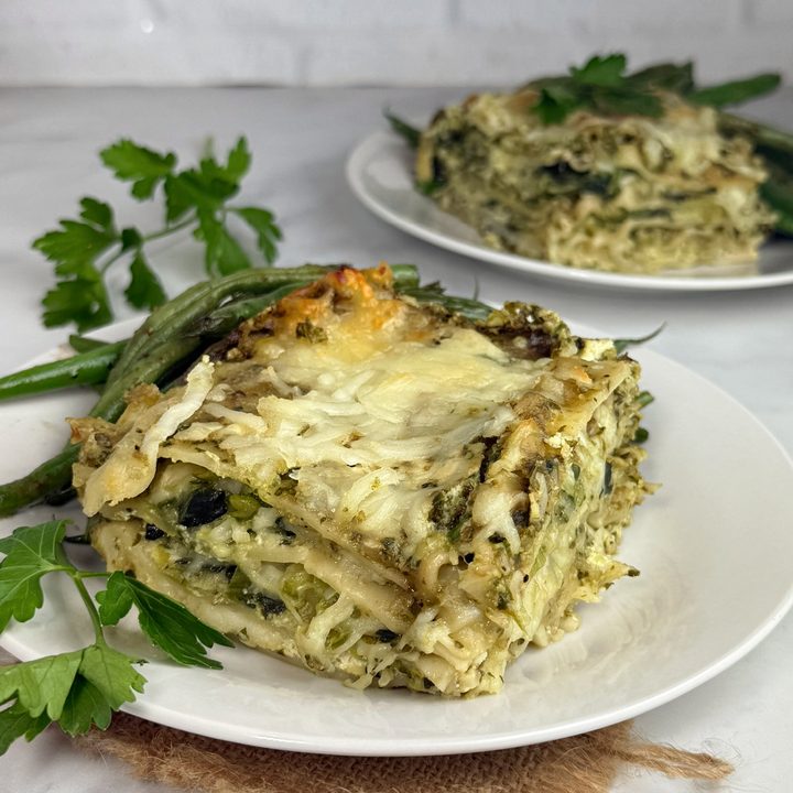 Zucchini and Spinach Pesto Lasagna with layers of tender lasagna noodles, creamy ricotta cheese, fresh zucchini, spinach, basil pesto, and melted part-skim mozzarella cheese baked to golden perfection.